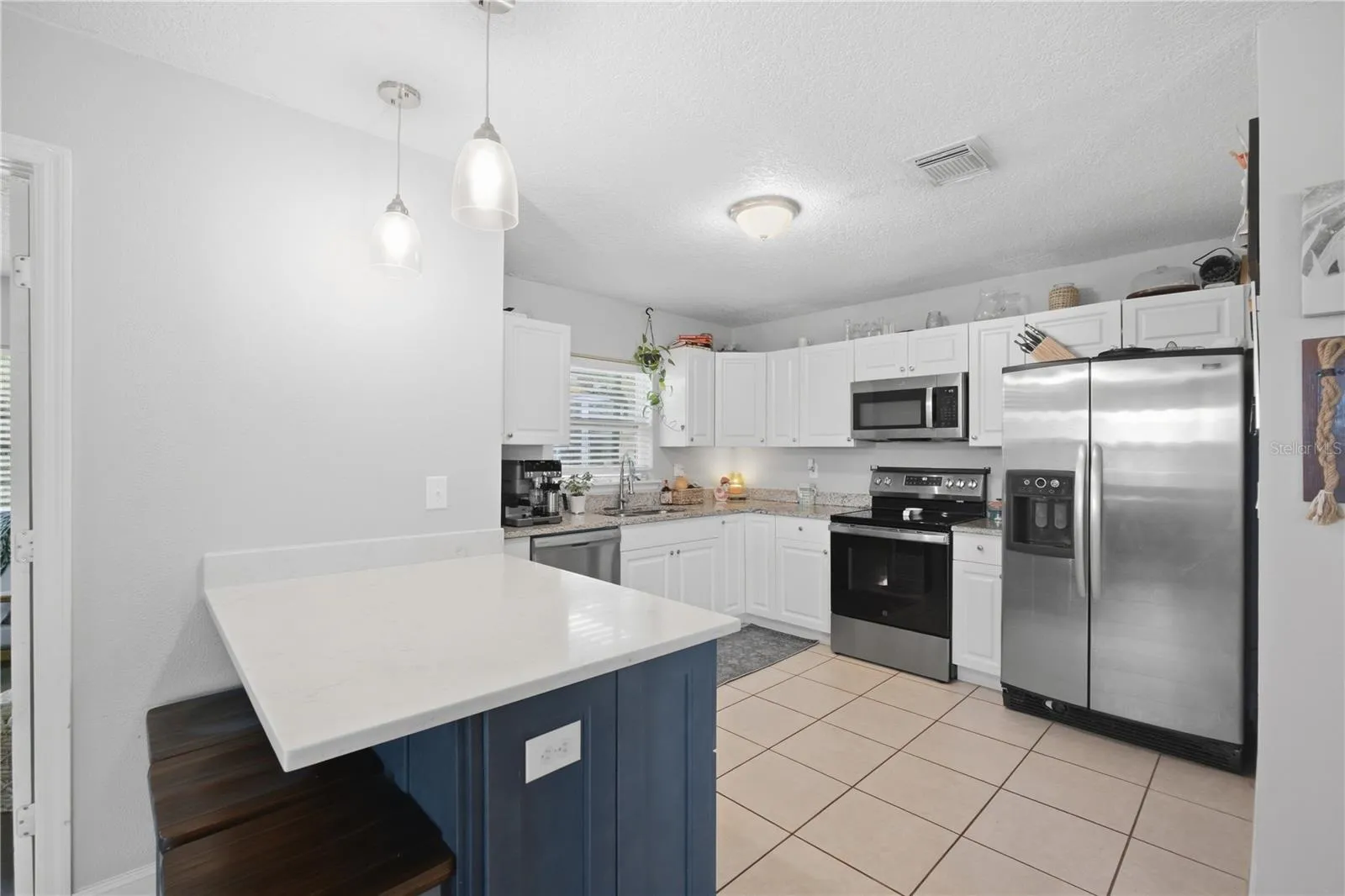 View of the kitchen with plenty of cabinets.
