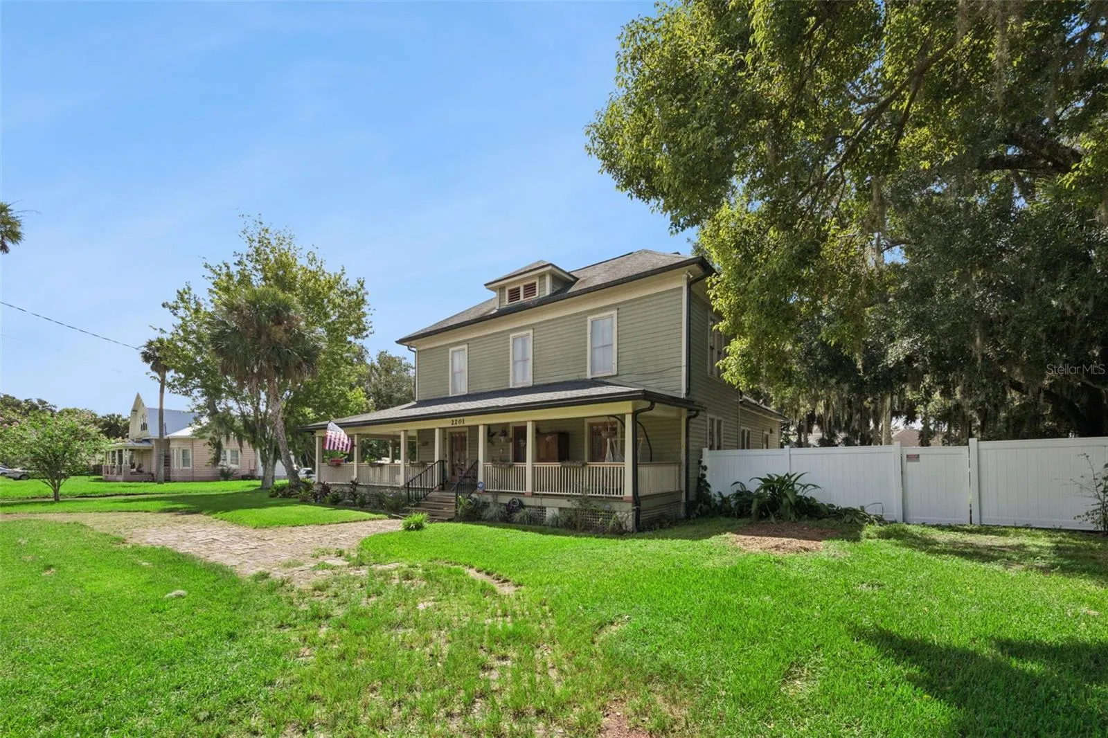 A closer look at the home's historic exterior, mature setting and impressive wraparound porch.