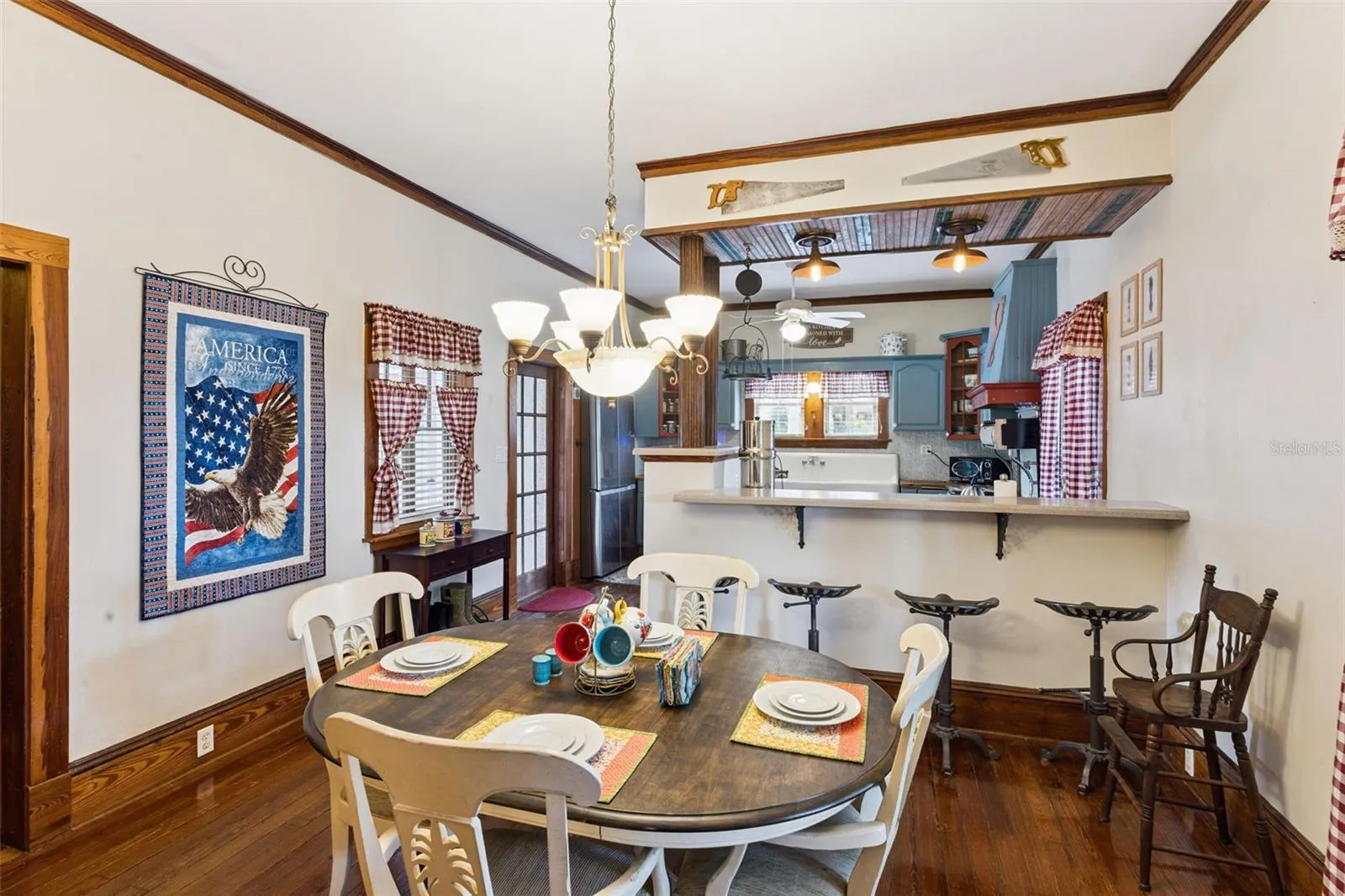 The generous dining room features another fireplace, original wood floors and an easy connection to the kitchen.