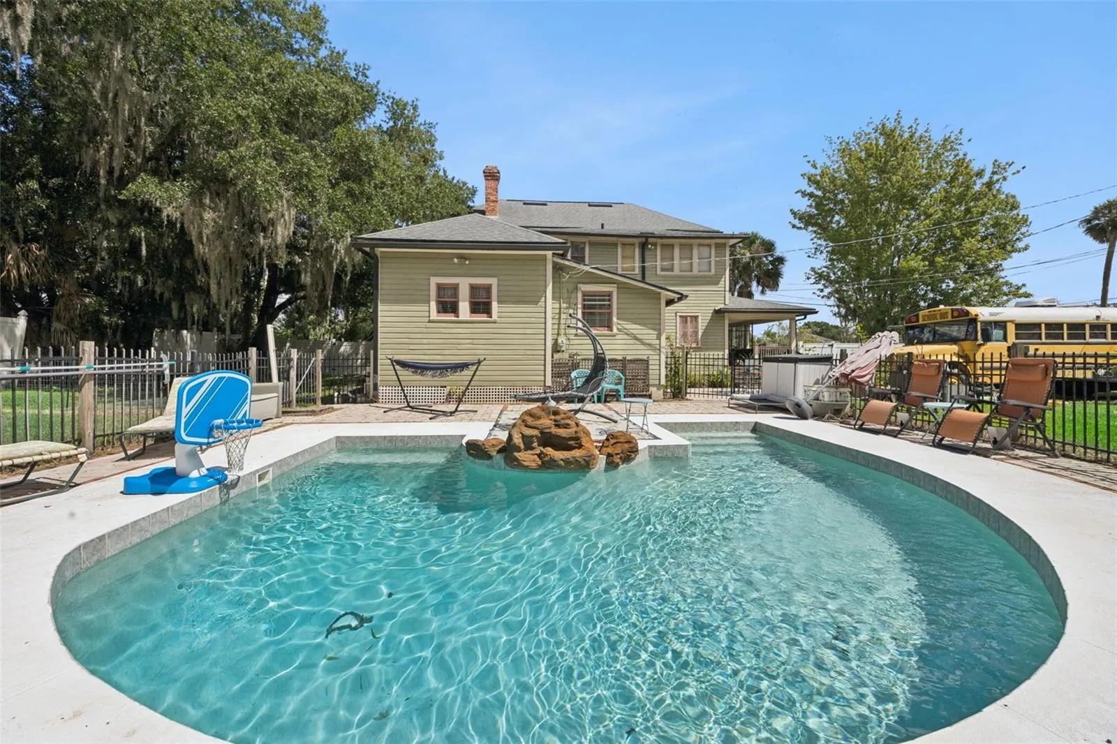 A private saltwater pool brings Florida living home, surrounded by outdoor entertaining space and the property's expansive grounds.
