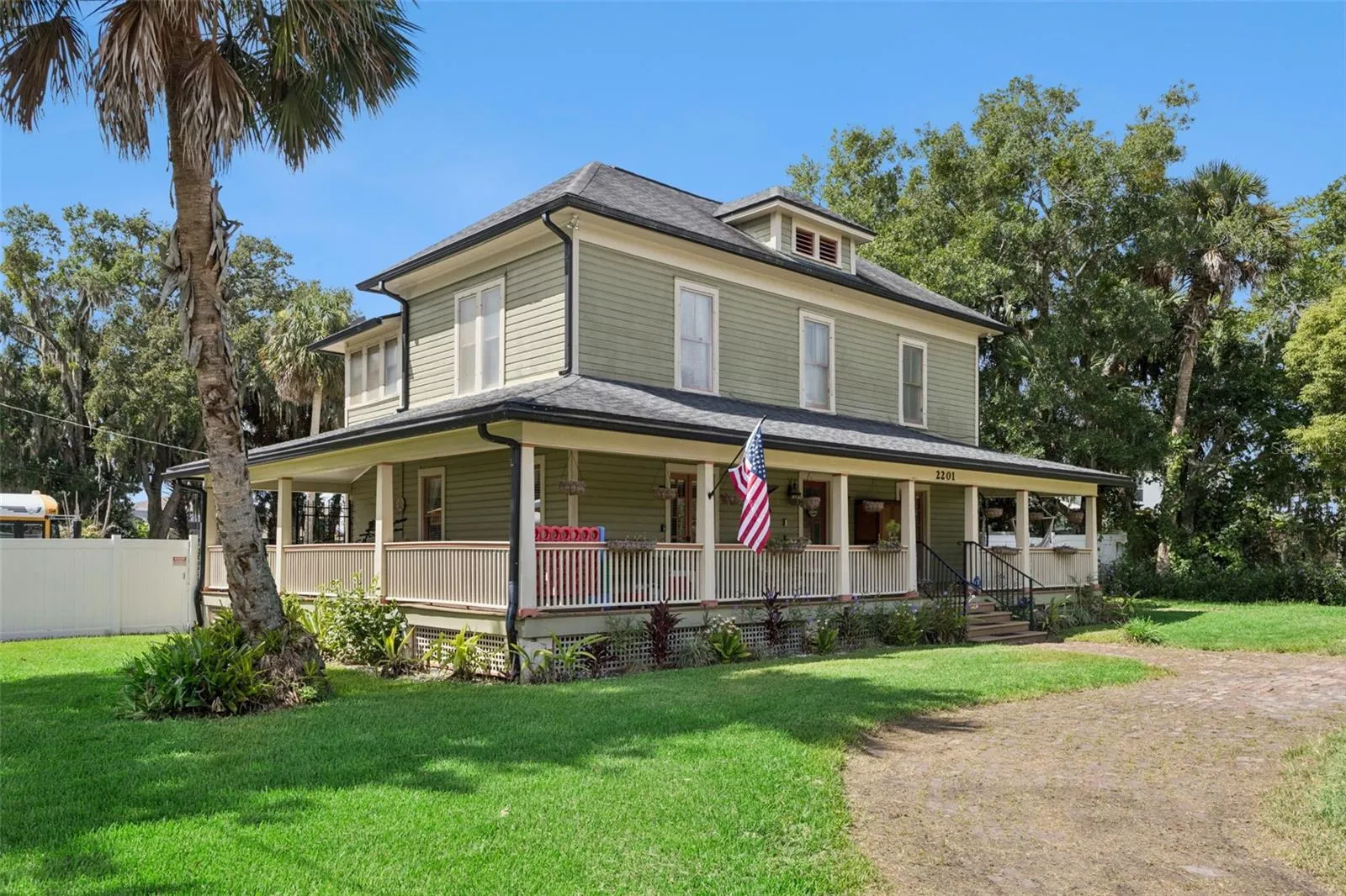 Classic architecture and an expansive wraparound front porch create an unmistakable sense of arrival.