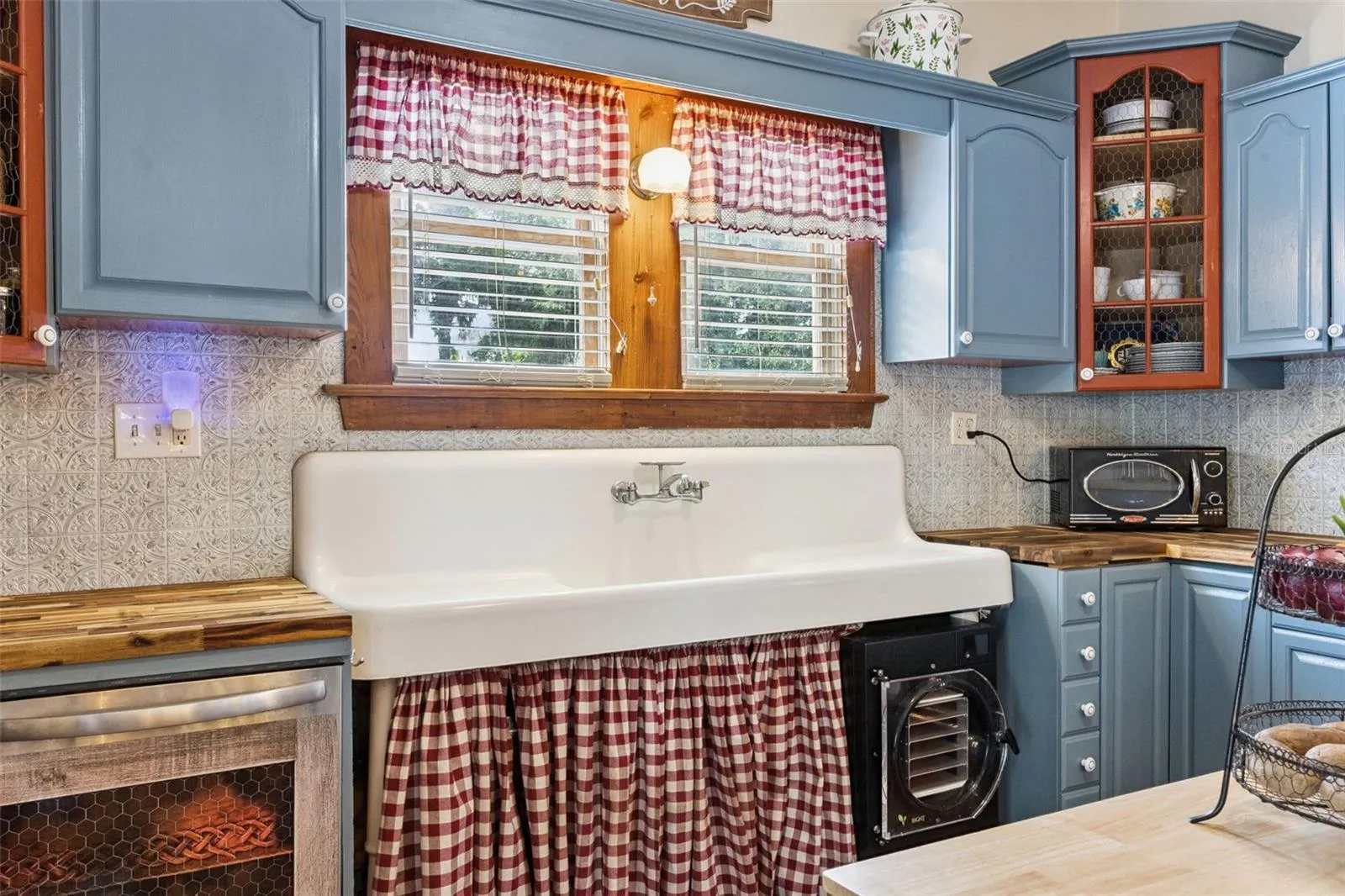 A reverse view highlights additional workspace, storage, stainless-steel refrigeration and the kitchen's functional layout.