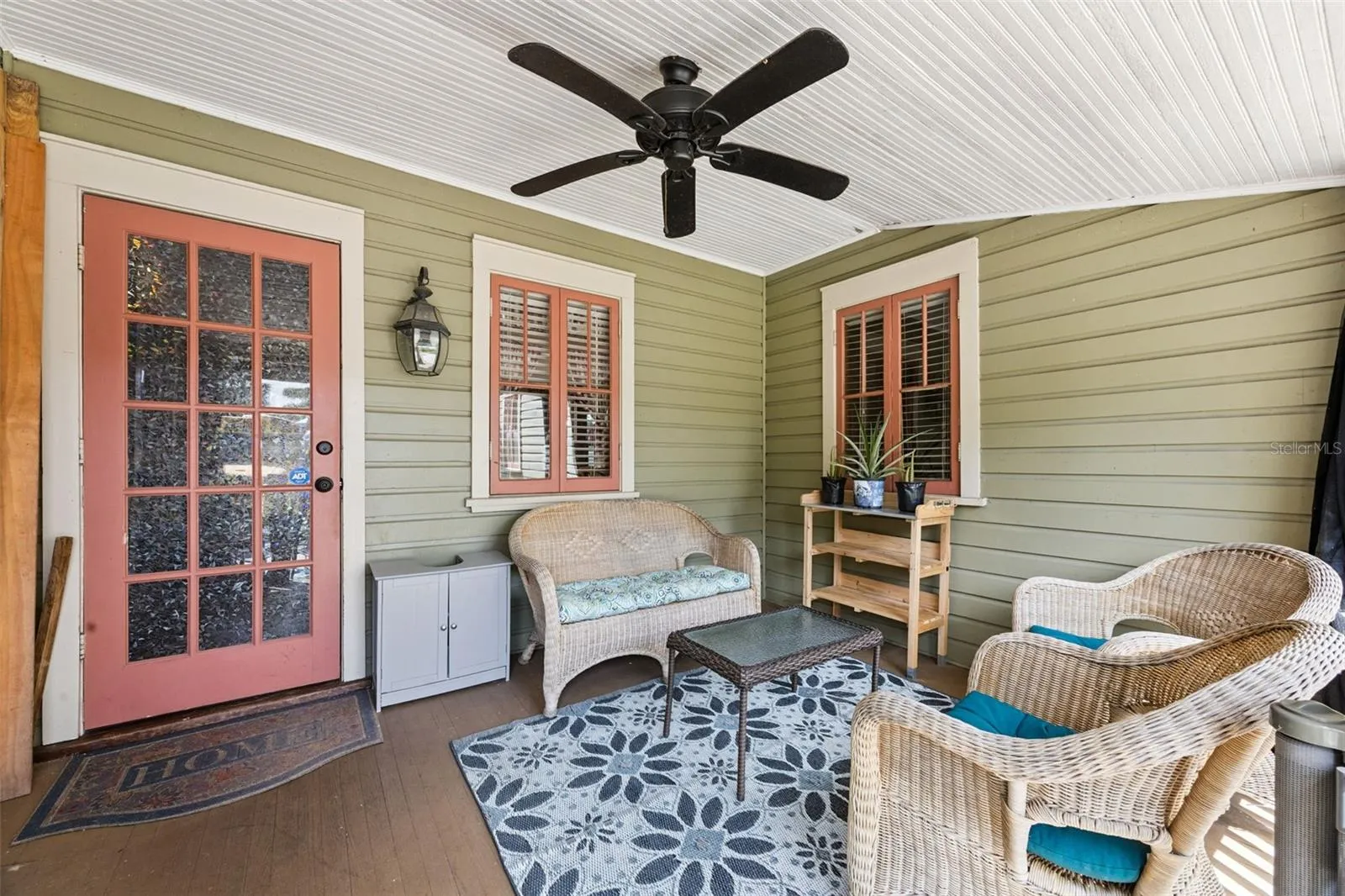 Another inviting corner of the covered porch creates a comfortable outdoor sitting room.