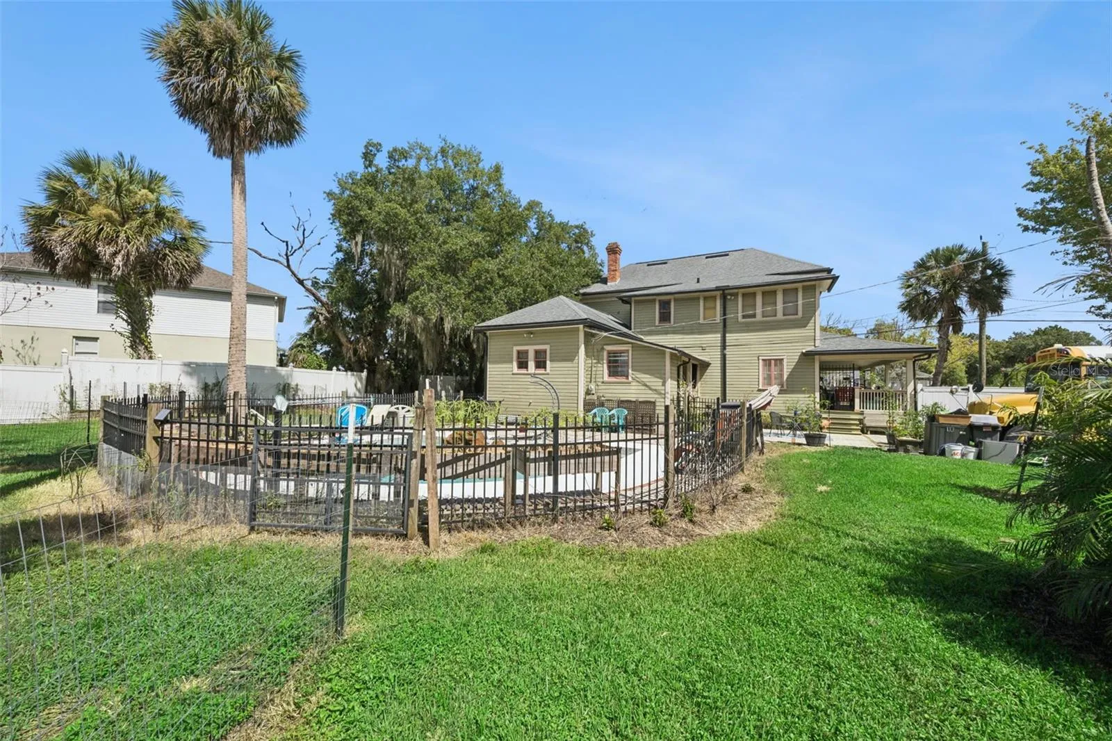 Gather around the backyard firepit beneath mature palms and shade trees — another outdoor space designed to be enjoyed.