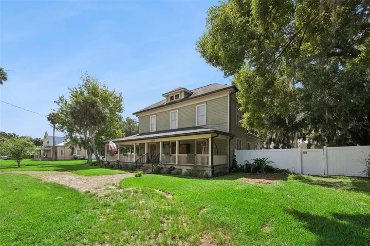A closer look at the home's historic exterior, mature setting and impressive wraparound porch.