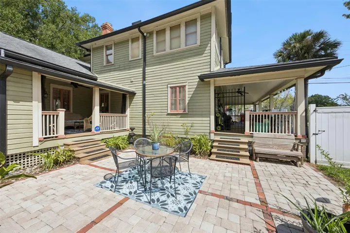An expansive paver courtyard creates a substantial outdoor entertaining area between the home, porch and pool.