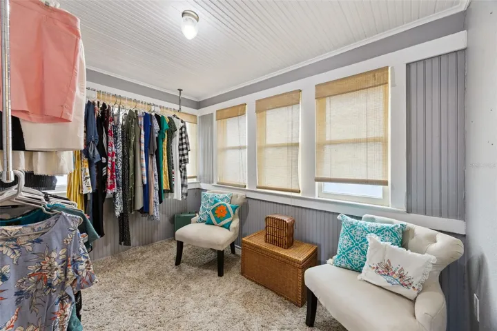 A former sleeping porch now offers wonderfully flexible bonus space — currently used as a dressing room and surrounded by windows.