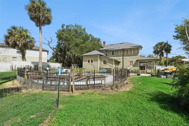 Gather around the backyard firepit beneath mature palms and shade trees — another outdoor space designed to be enjoyed.