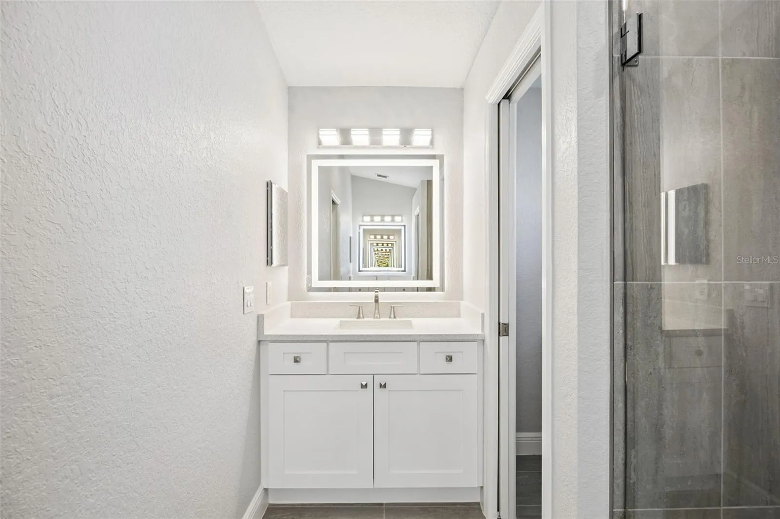 His & Her tall vanities with Quartz top, soft-close hinges (even on the medicaine cabinets), touch lighting/mirror (dimmable)