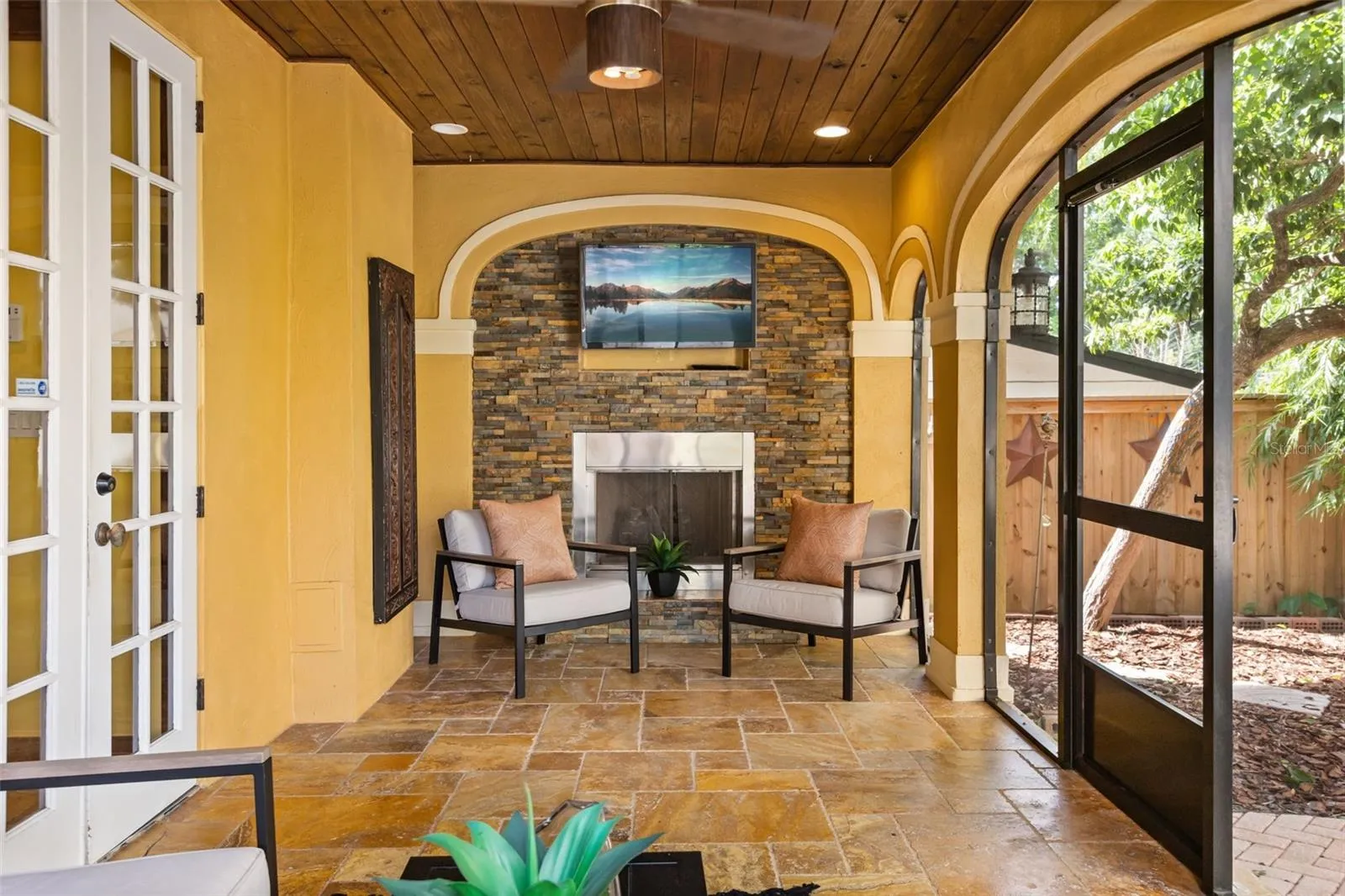Screened in porch with gas fireplace off kitchen