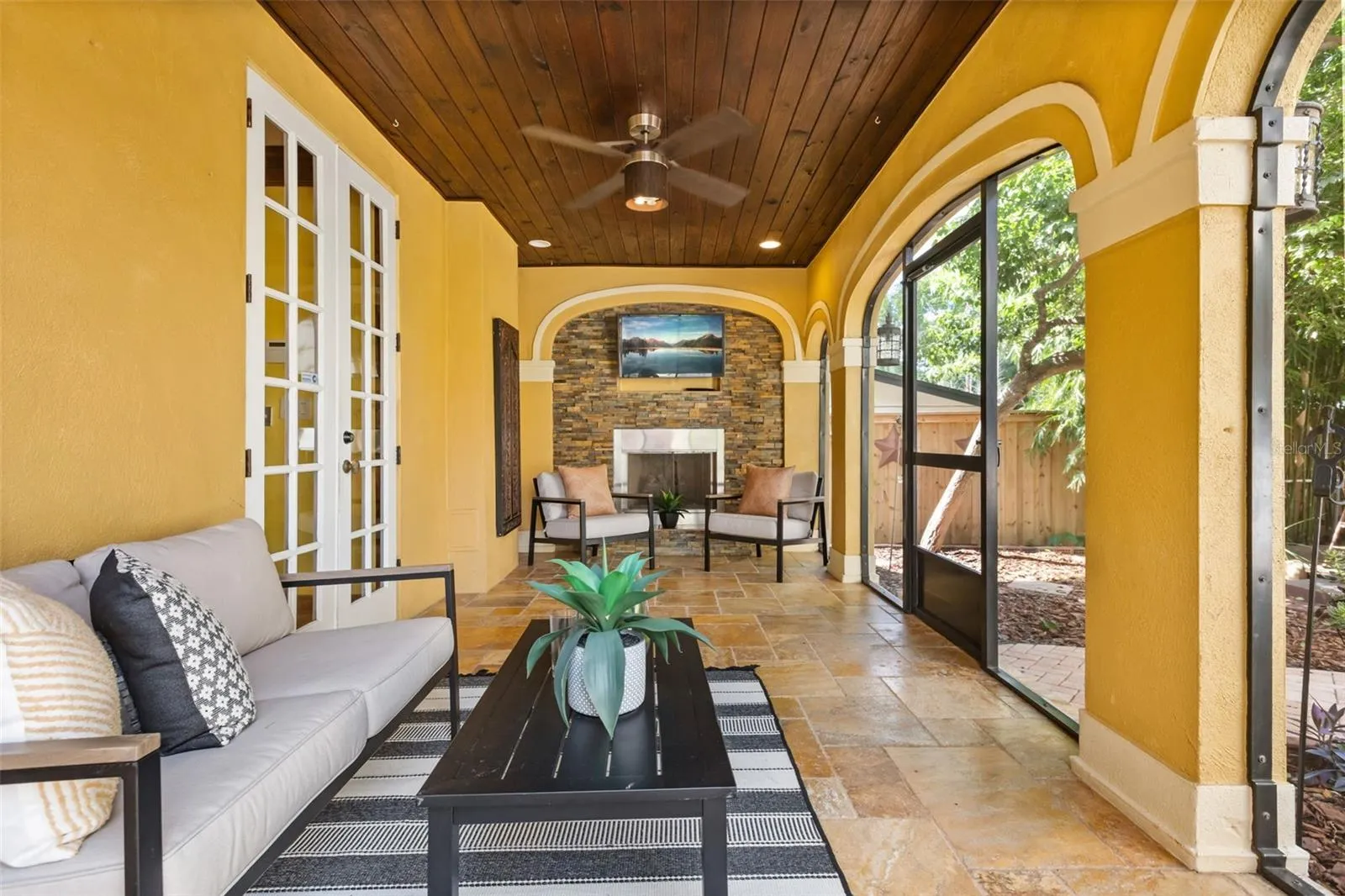 Screened in porch with gas fireplace off kitchen