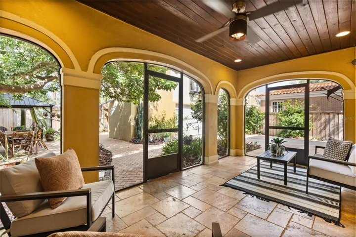 Screened in porch with gas fireplace off kitchen