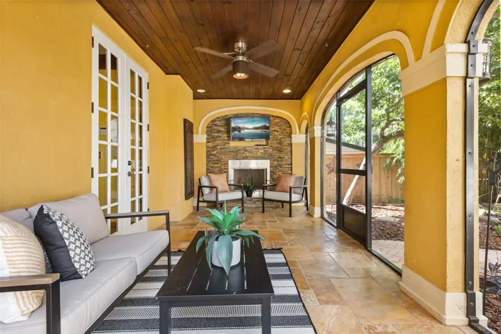 Screened in porch with gas fireplace off kitchen