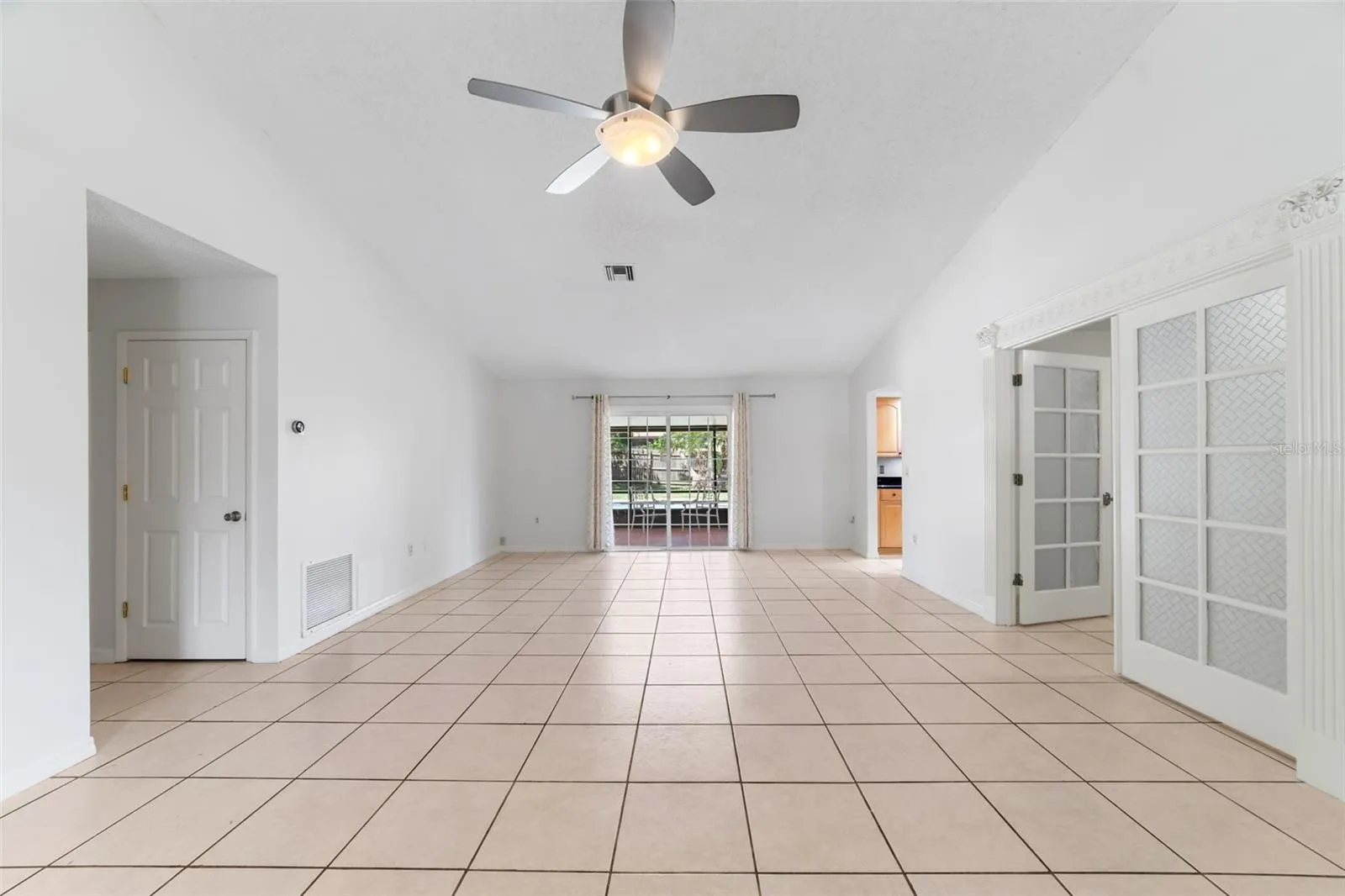 Open concept floor plan with sliding glass doors that open to a screened lanai for the ultimate in indoor/outdoor living.