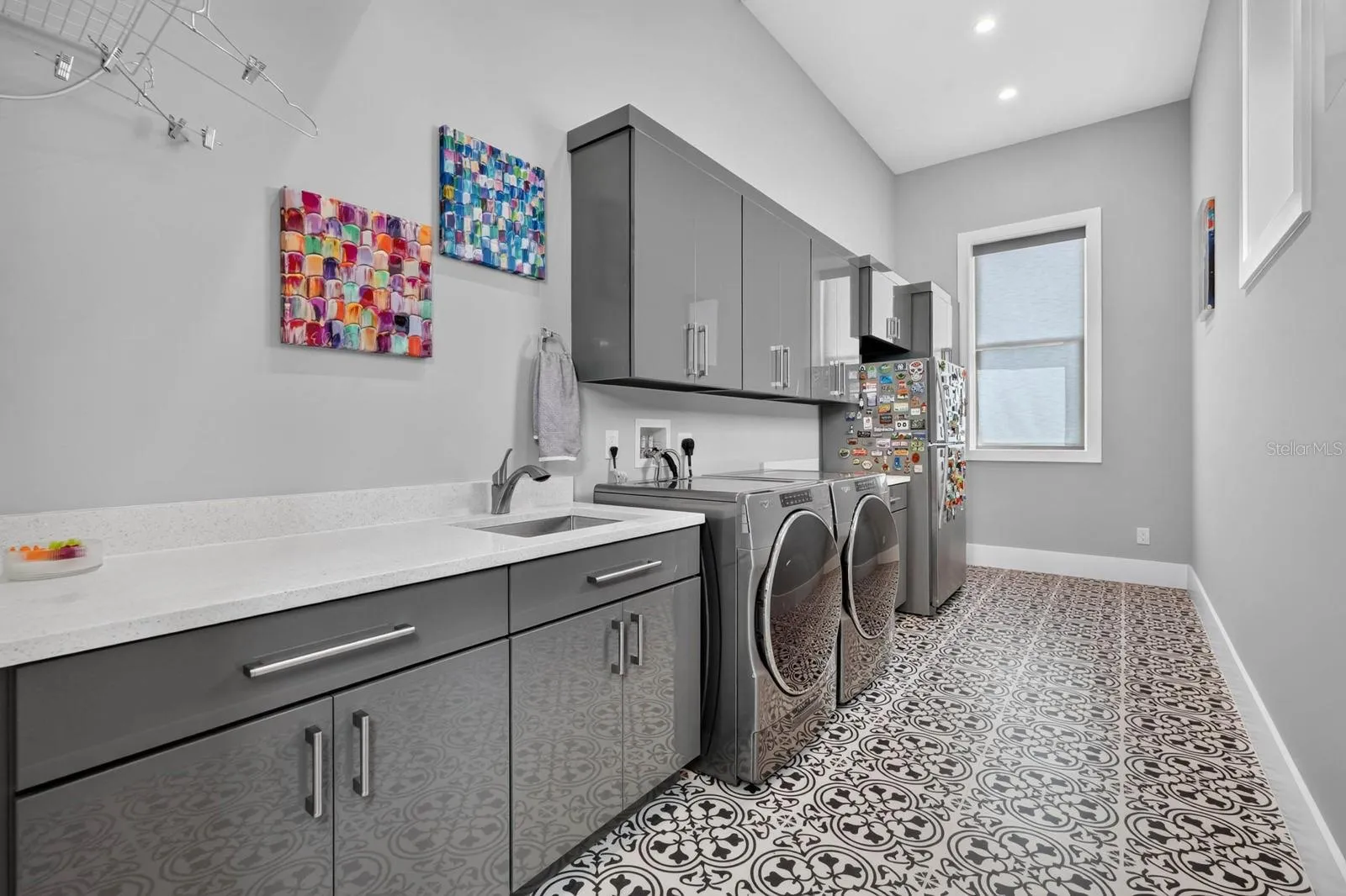 Even the laundry room was given room to work—generous cabinetry, expansive counter space, utility sink and plenty of space for everyday organization.