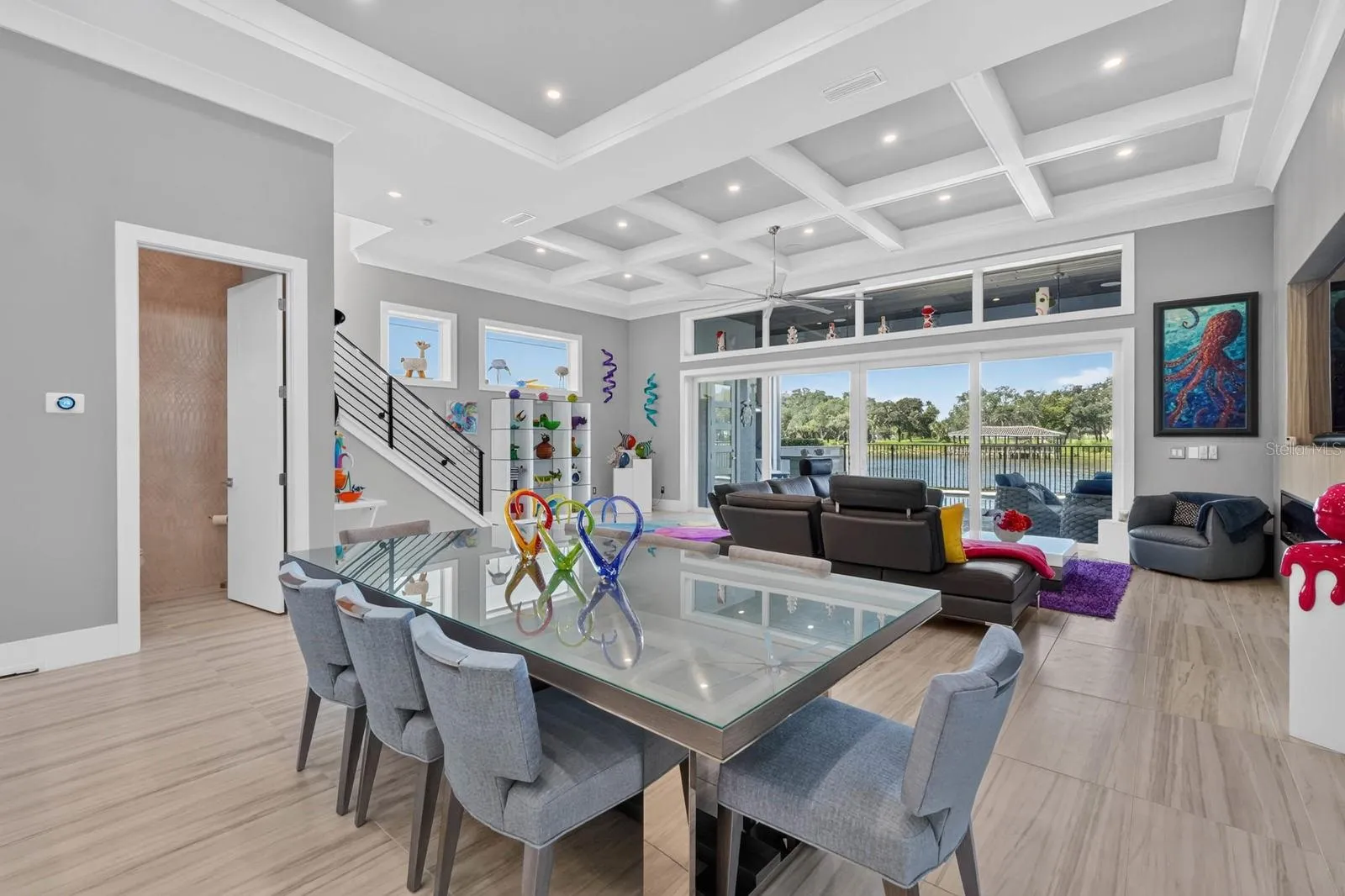 Soaring ceilings, detailed millwork and walls of glass give the main living level its sense of scale, while the open design keeps the water beautifully in view.