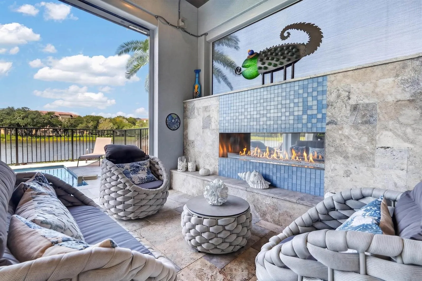 Indoor-outdoor living was part of the design. Covered poolside living with an outdoor gas fireplace, custom hurricane-rated screens and uninterrupted views of the Intracoastal.