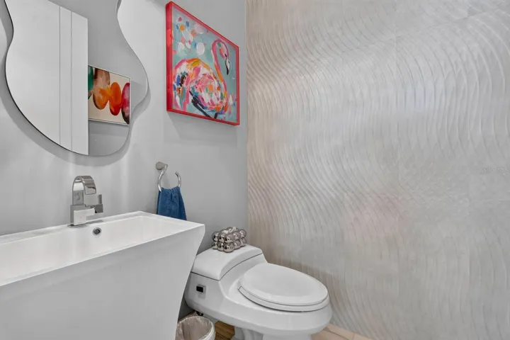 Even the first-floor powder bath makes a statement, with sculptural fixtures, dimensional wall detail.