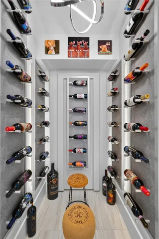 Now this is a wine room. Custom illuminated bottle displays transform this dedicated space into something that feels as much like an art installation as wine storage.