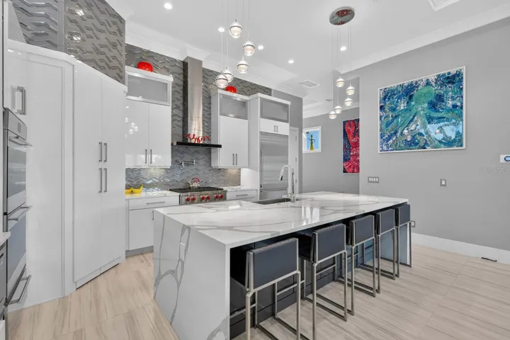 The island is where everyone ends up anyway. Generous seating, abundant prep space and an open layout make this kitchen as social as it is functional.