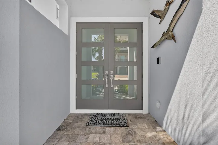 The details begin at the front door. Contemporary double-door entry sets the tone for the custom finishes found throughout the home.