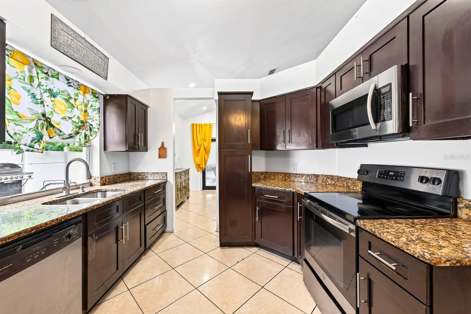 The spacious Kitchen is designed for both everyday meals and entertaining, offering STONE COUNTERTOPS, abundant cabinetry, and STAINLESS STEEL APPLIANCES.