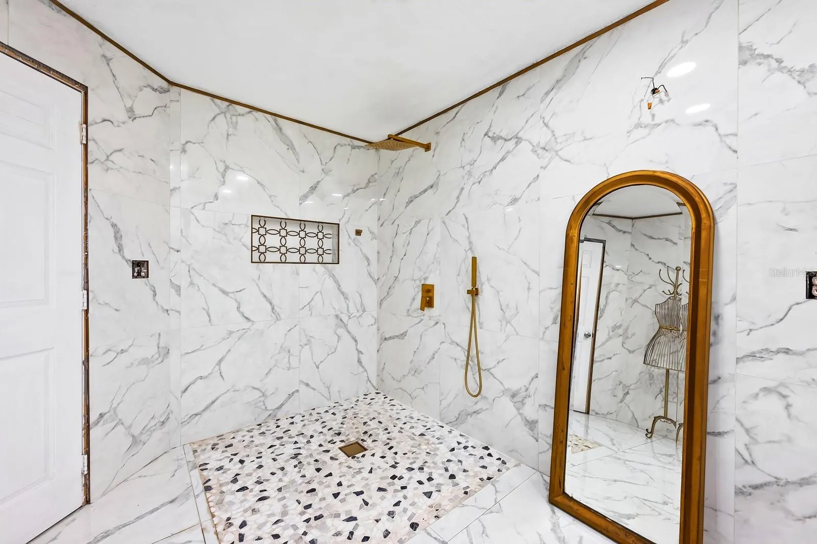The generous bath delivers a spa-like feel with a generous WALK-IN SHOWER, rain shower head and MARBLE-LOOK TILE.