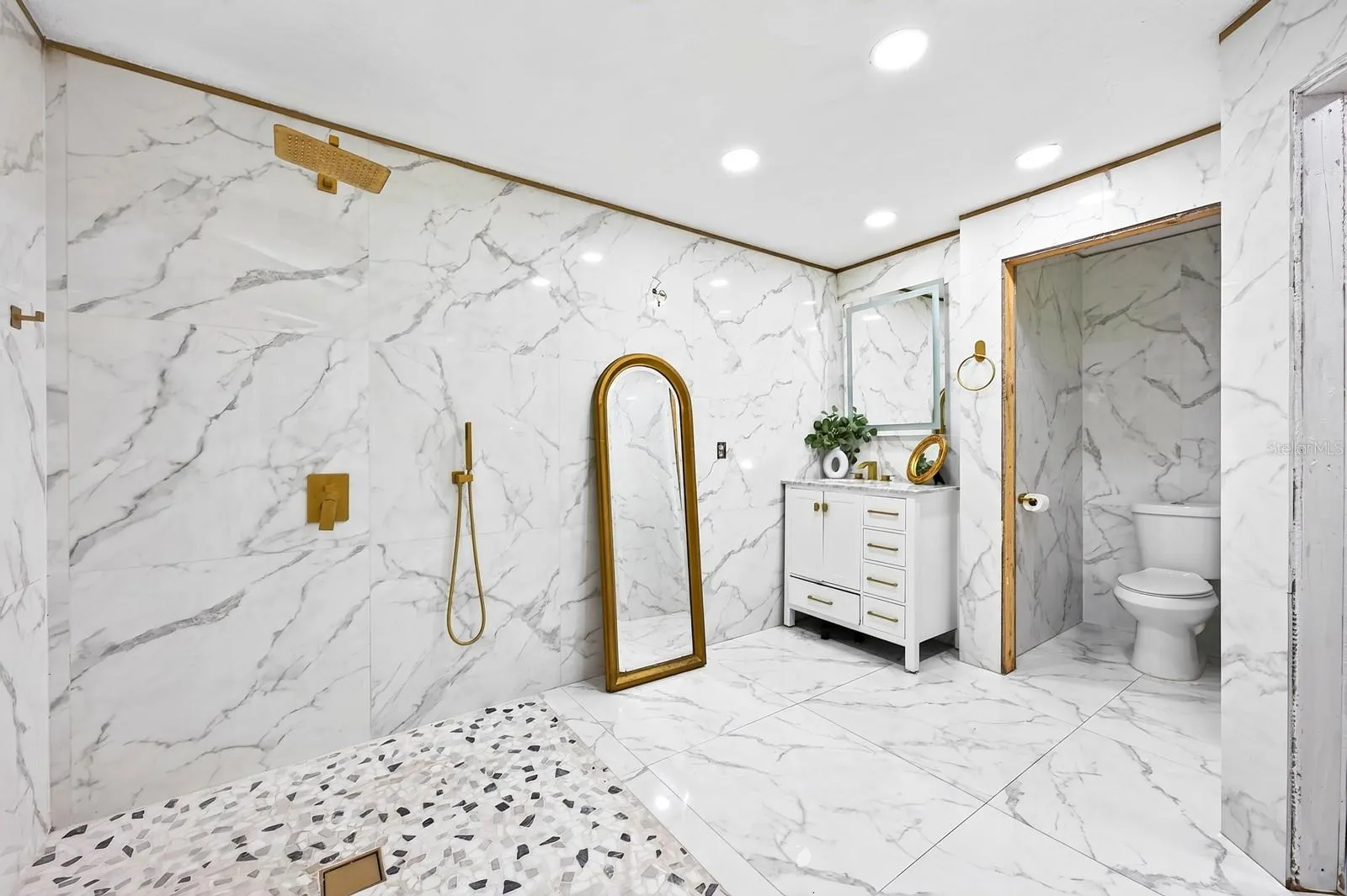 The generous bath delivers a spa-like feel with a generous WALK-IN SHOWER, rain shower head and MARBLE-LOOK TILE.