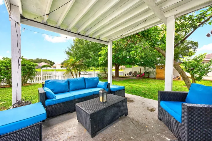 Step outside where the VINYL-FENCED YARD takes full advantage of the PEACEFUL LAKE SETTING as you relax on the COVERED PATIO and enjoy the water view.