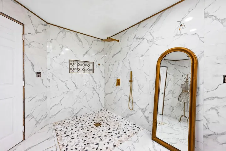 The generous bath delivers a spa-like feel with a generous WALK-IN SHOWER, rain shower head and MARBLE-LOOK TILE.