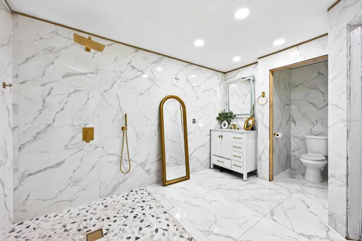 The generous bath delivers a spa-like feel with a generous WALK-IN SHOWER, rain shower head and MARBLE-LOOK TILE.