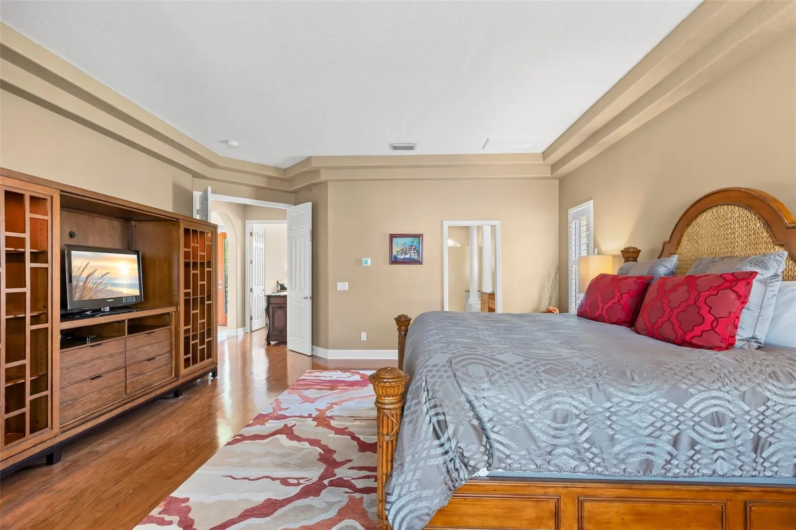Beautiful Wood Floors and Tray Ceiling accents inhance the Primary Bedroom