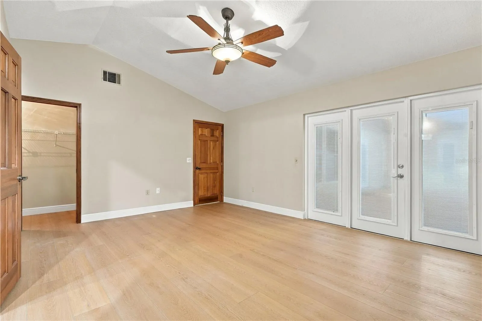 Spacious primary bedroom with access to the outdoor living area.
