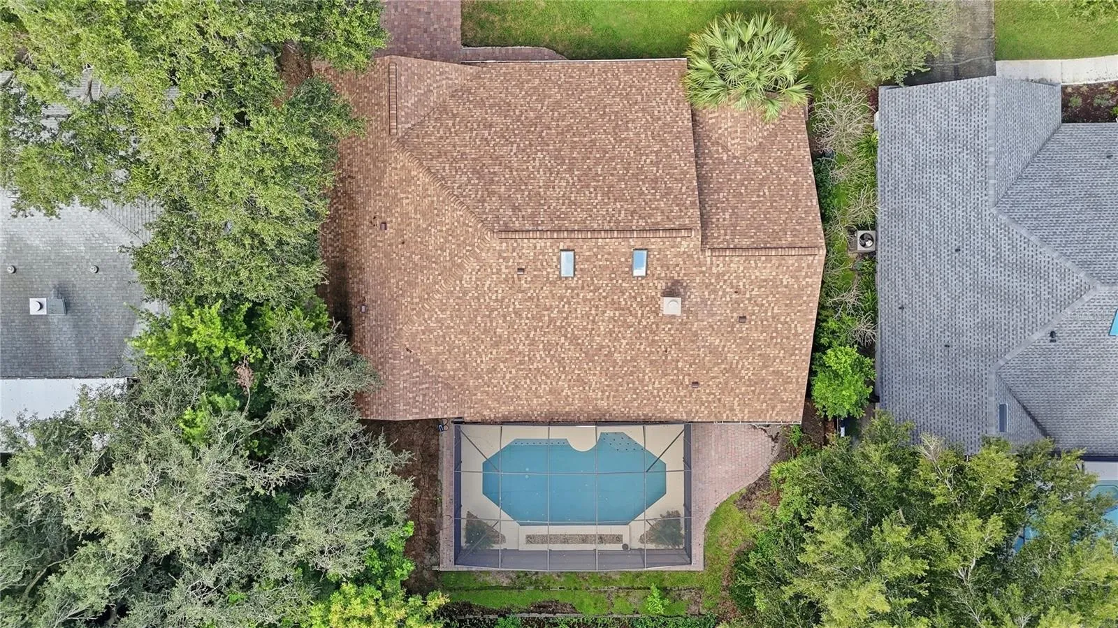 Aerial view showcasing the home, pool, and lot.