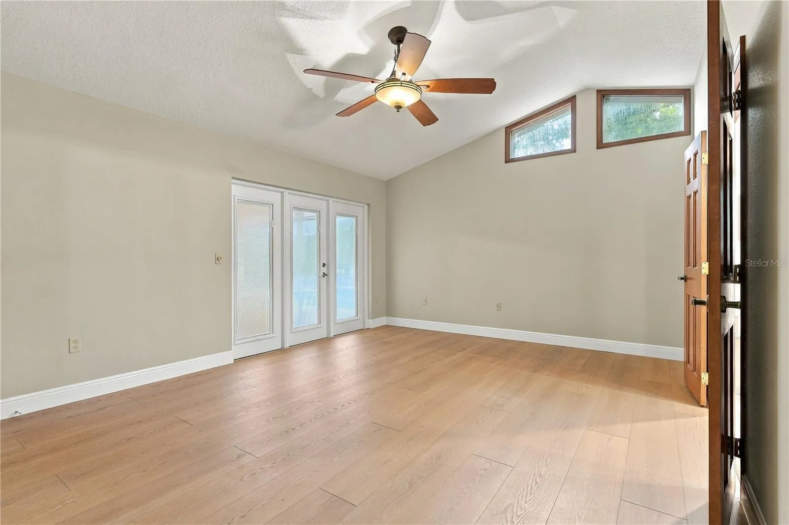 Spacious primary bedroom with abundant natural light.