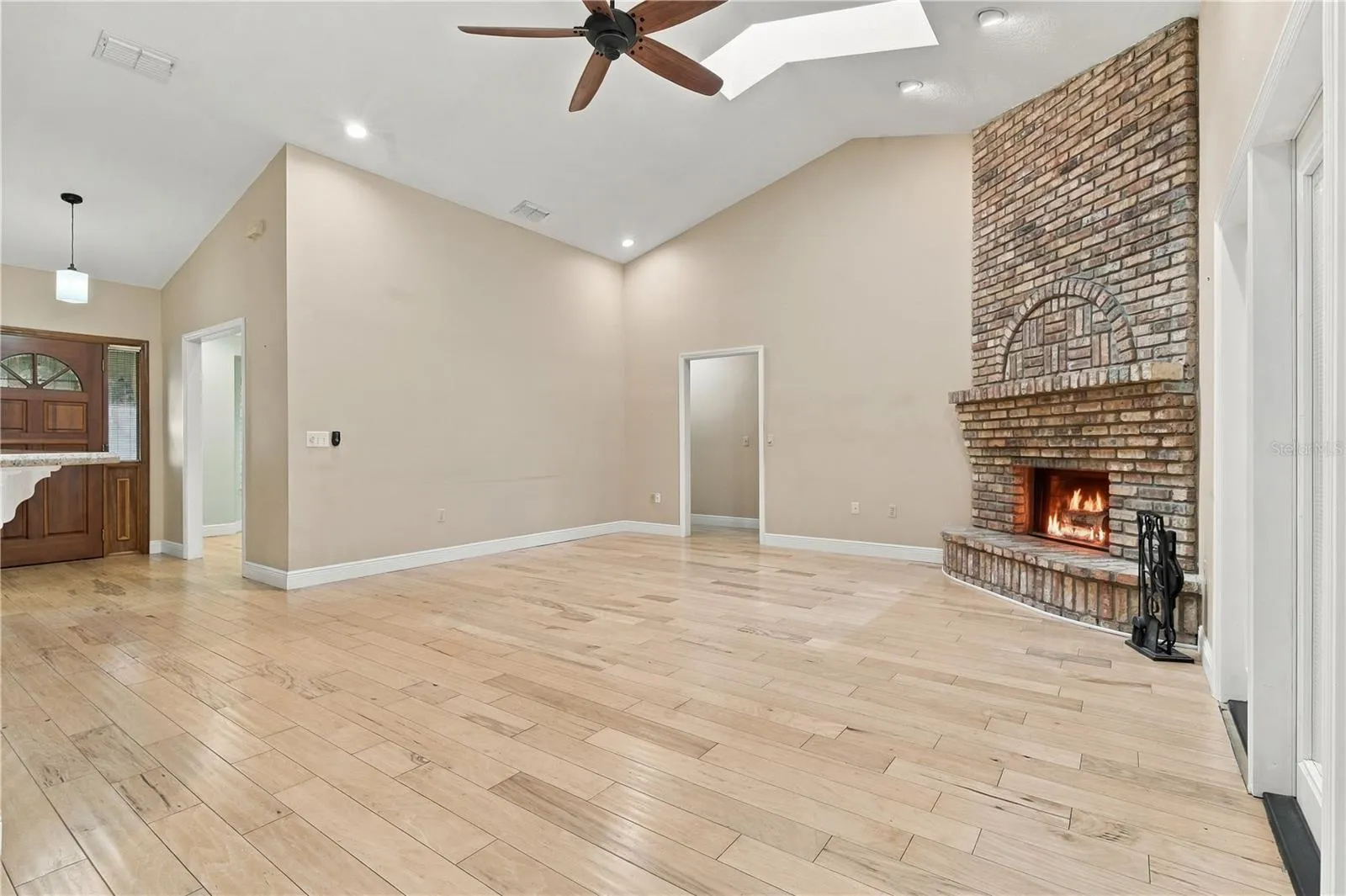 Open family room with fireplace and flexible living space.