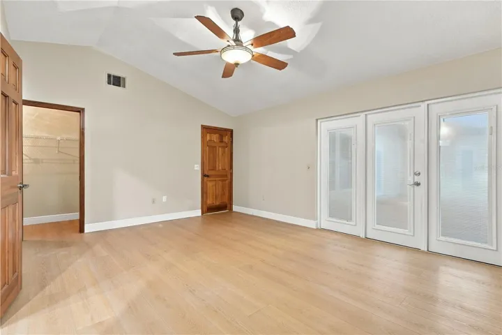 Spacious primary bedroom with access to the outdoor living area.