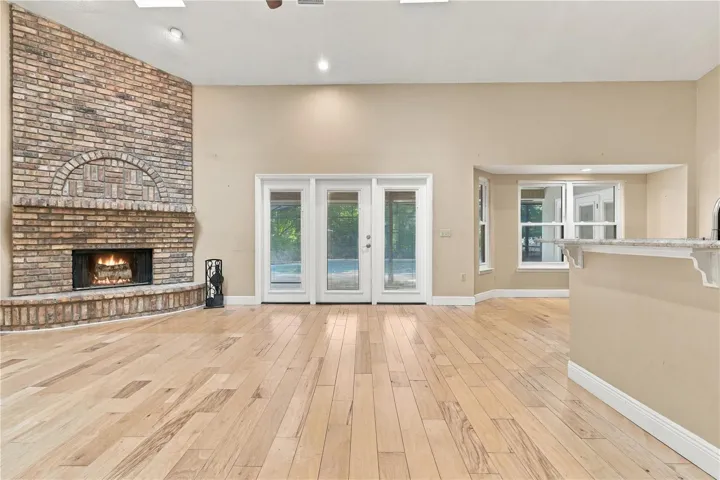 Spacious family room with fireplace and abundant natural light.