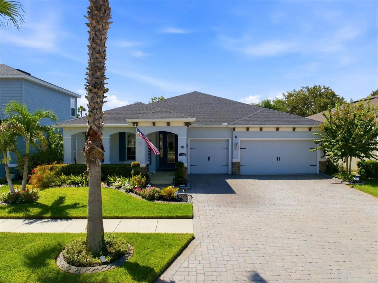 Original-owner home with a 3-car garage, paver driveway and thoughtfully upgraded landscaping.