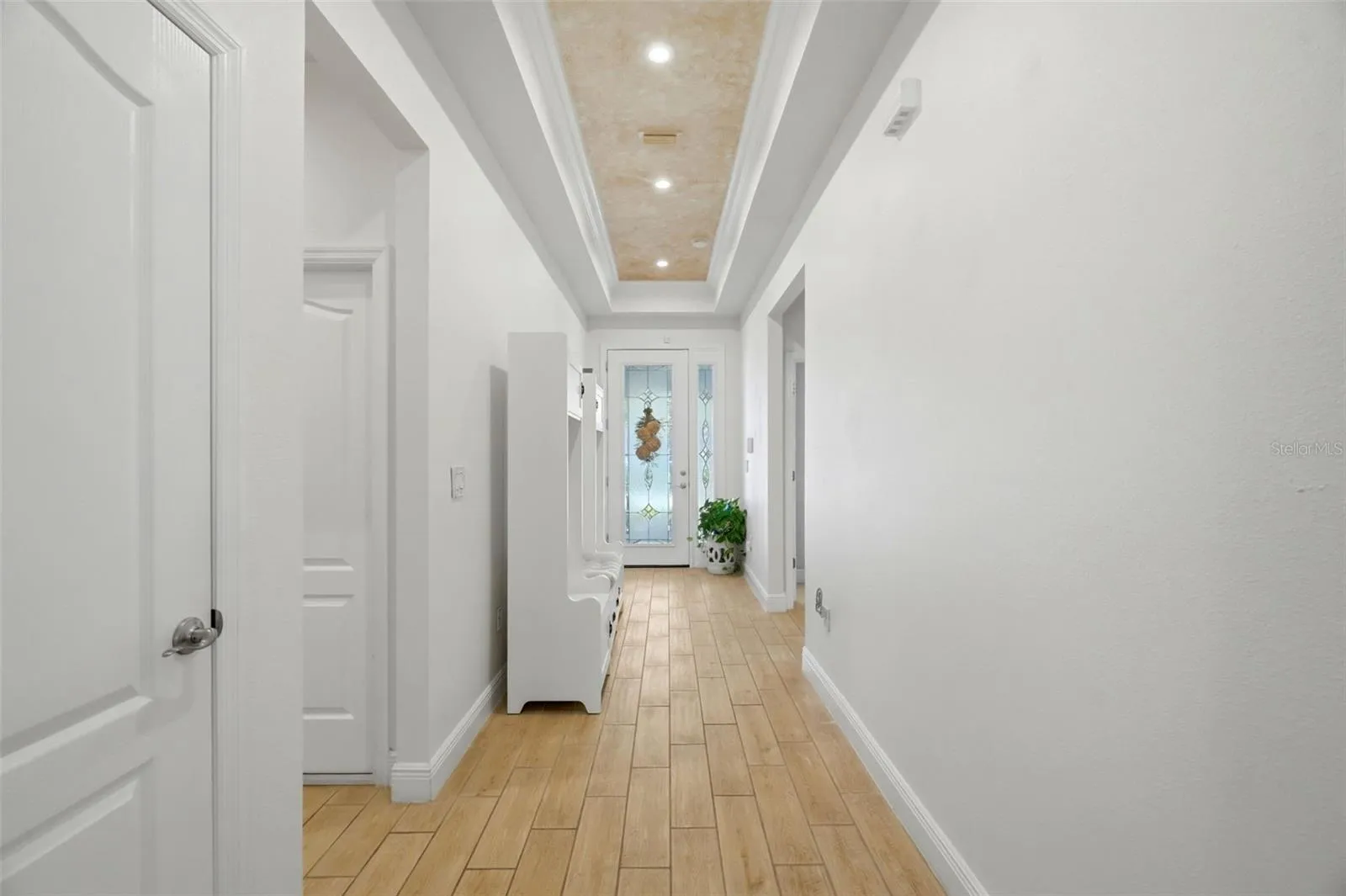 Custom decorative ceiling finish and recessed lighting add detail beyond the original builder package.
