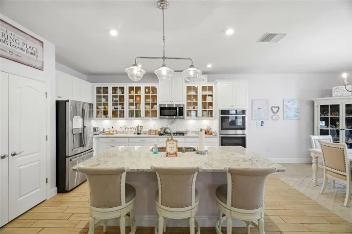 Large center island provides additional prep space, storage and seating.