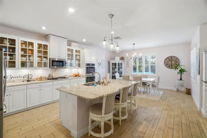 Glass-front cabinetry adds a custom touch to the kitchen design.