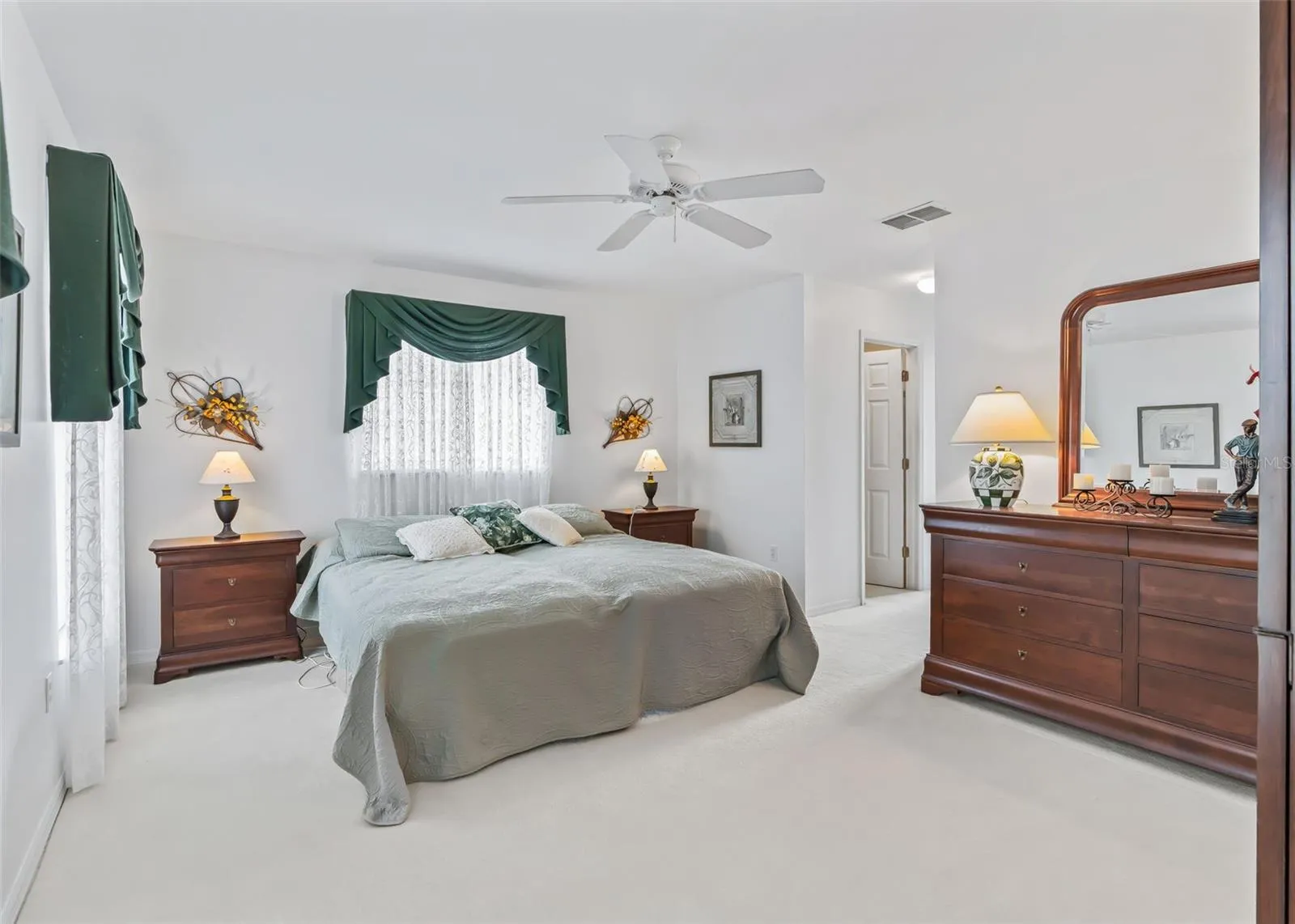 Very spacious primary suite offers plenty of room to relax and unwind, featuring two walk-in closets for exceptional storage and convenience.