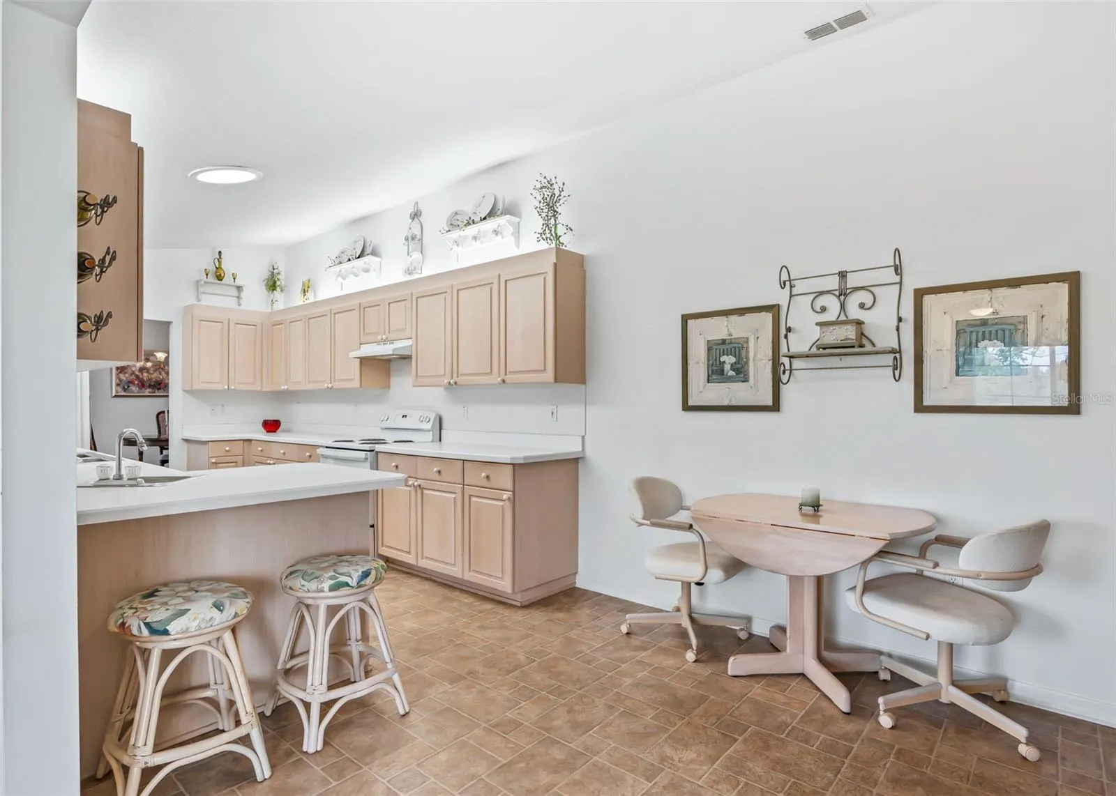 The open layout flows naturally into the dining space, creating a comfortable setting for casual meals, entertaining, and everyday living.