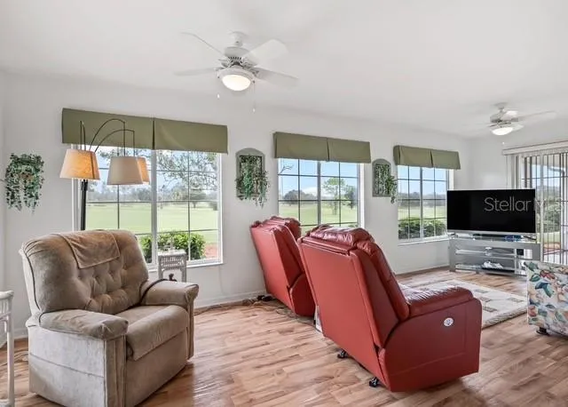 The kitchen opens to a spacious bonus living area, creating a wonderful extension of the home’s main living space. Sliding glass doors provide easy access to the enclosed lanai, where you can relax and enjoy beautiful golf course views right from your own backyard.