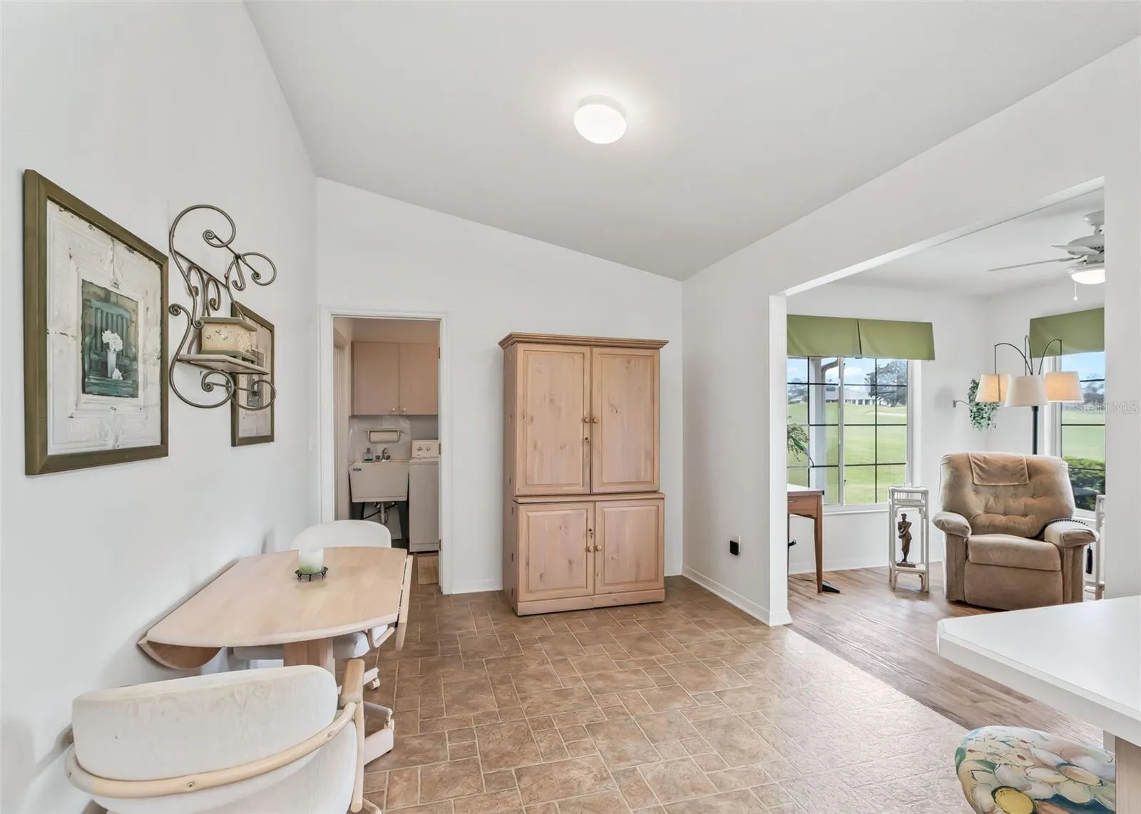 Bright and inviting kitchen that opens seamlessly to the additional living space, creating an open and connected layout. A convenient bar area provides comfortable seating at the counter, perfect for casual dining, entertaining, and everyday living.