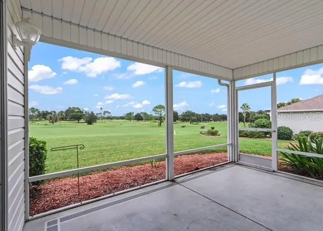 Beautiful enclosed lanai offers a peaceful place to relax and entertain while taking in breathtaking, panoramic views overlooking the golf course. This inviting space provides the perfect setting to enjoy the scenery and seamless indoor-outdoor living