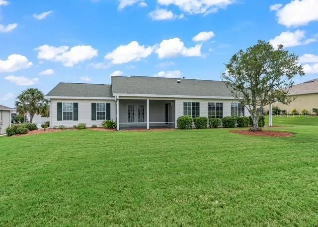 The back elevation showcases the home’s inviting exterior and provides a beautiful backdrop to the spacious backyard and stunning golf course views.