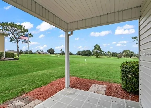 The convenient porch off the laundry room offers beautiful golf course views, providing a peaceful spot to step outside and enjoy the picturesque surroundings.