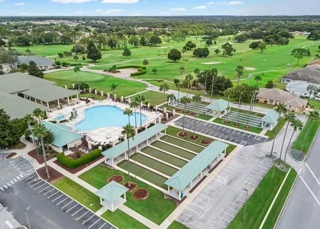 Aerial view showcases the community center and its surrounding amenities, highlighting the inviting community setting and convenient access to neighborhood gathering spaces.